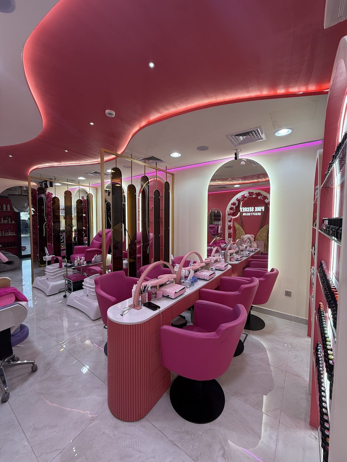 Bella Pink Secret salon interior with pink chairs and nail stations
